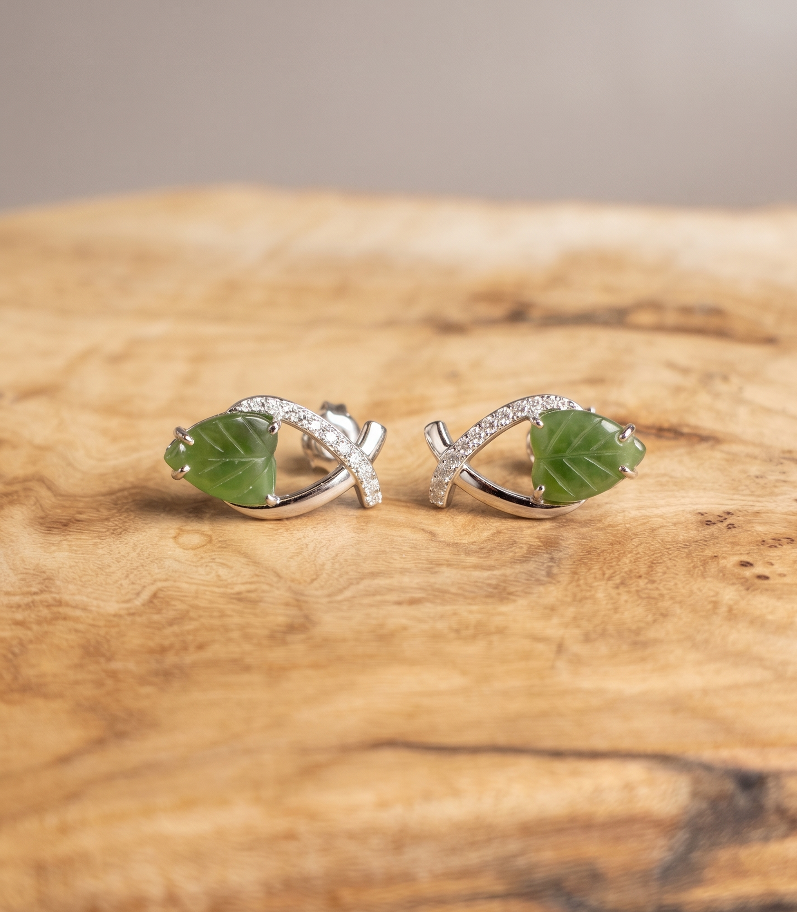 Canadian jade and silver leaf earrings on wood base