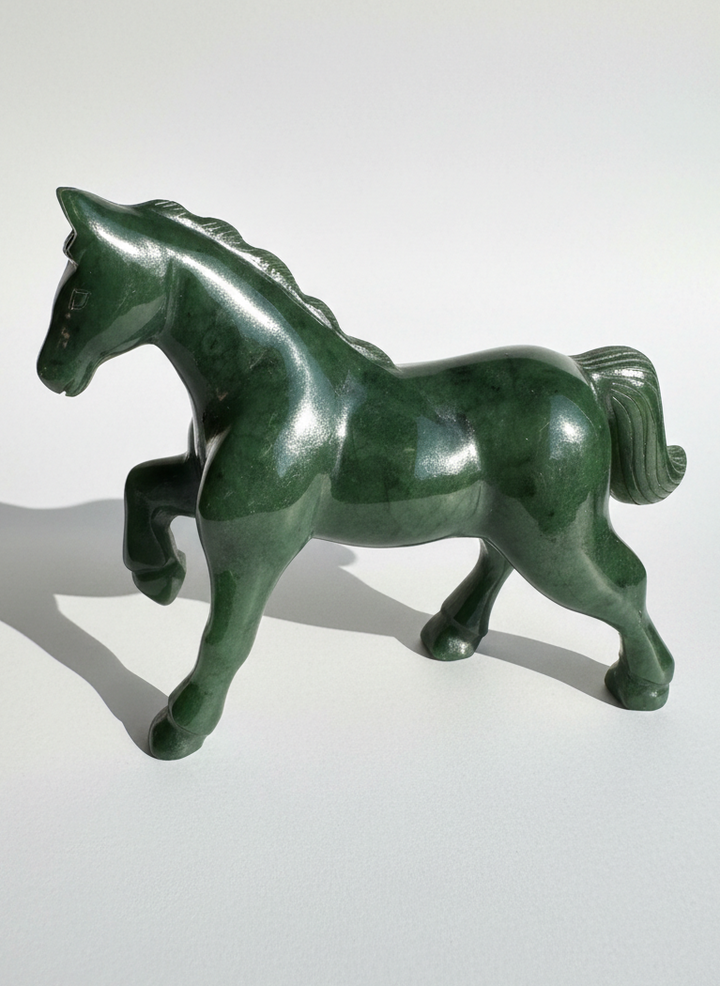 Canadian nephrite jade horse sculpture in deep green with a flowing mane and strong stance