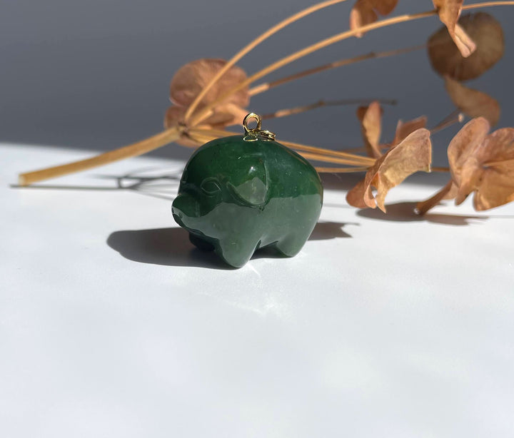 Cartoon Jade Pig Charm in dark green jade with a small gold loop on top