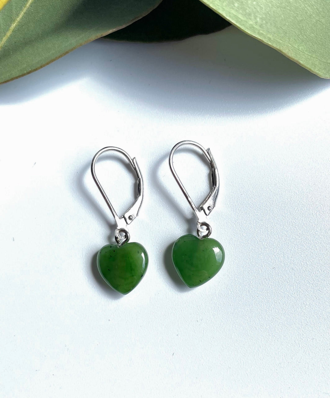 Pair of green jade heart earrings with silver ear wire hooks