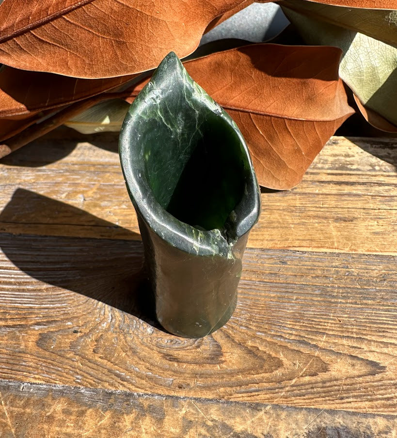 Dark green jade pen holder vase 4 inches with a wide opening on a wooden surface