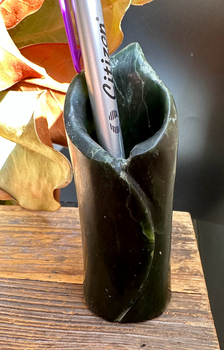 Close-up of the jade pen holder with a silver pen inside