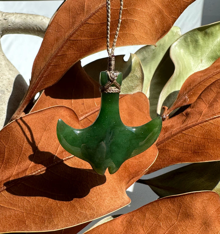 Green manta ray pendant on a beaded necklace with round green beads and metal spacers
