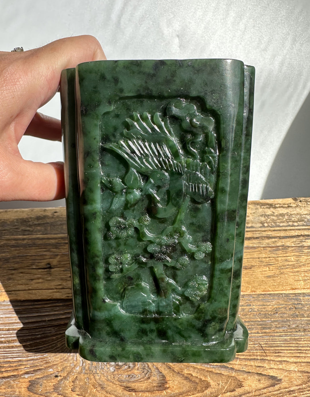 Person holding River Jade Vase-Pen Holder showing the carved panel on the jade block