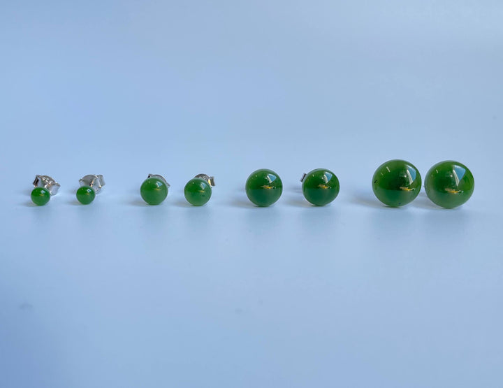 Jade flat stud earrings in multiple sizes arranged in a row from small to large