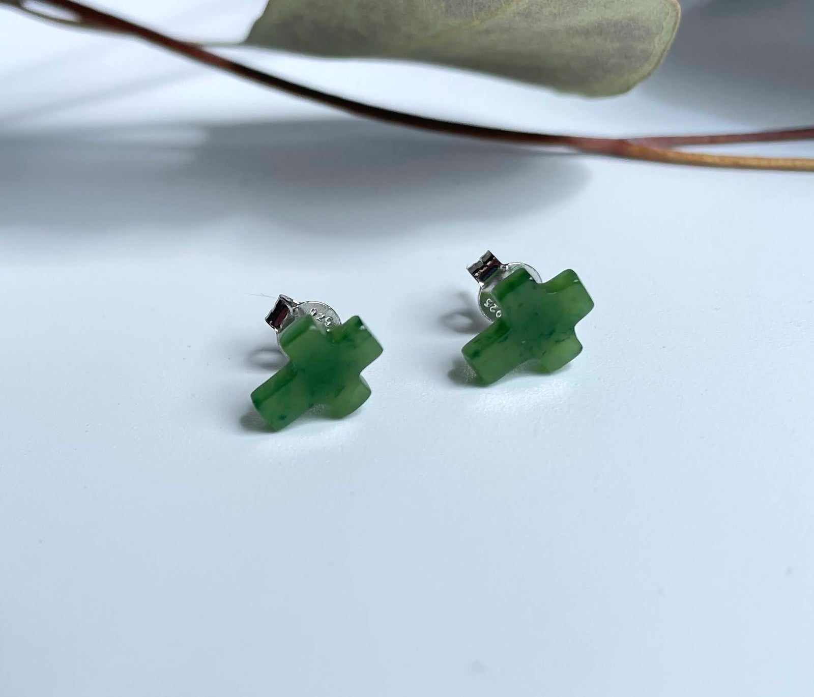Pair of small green jade cross stud earrings with silver posts