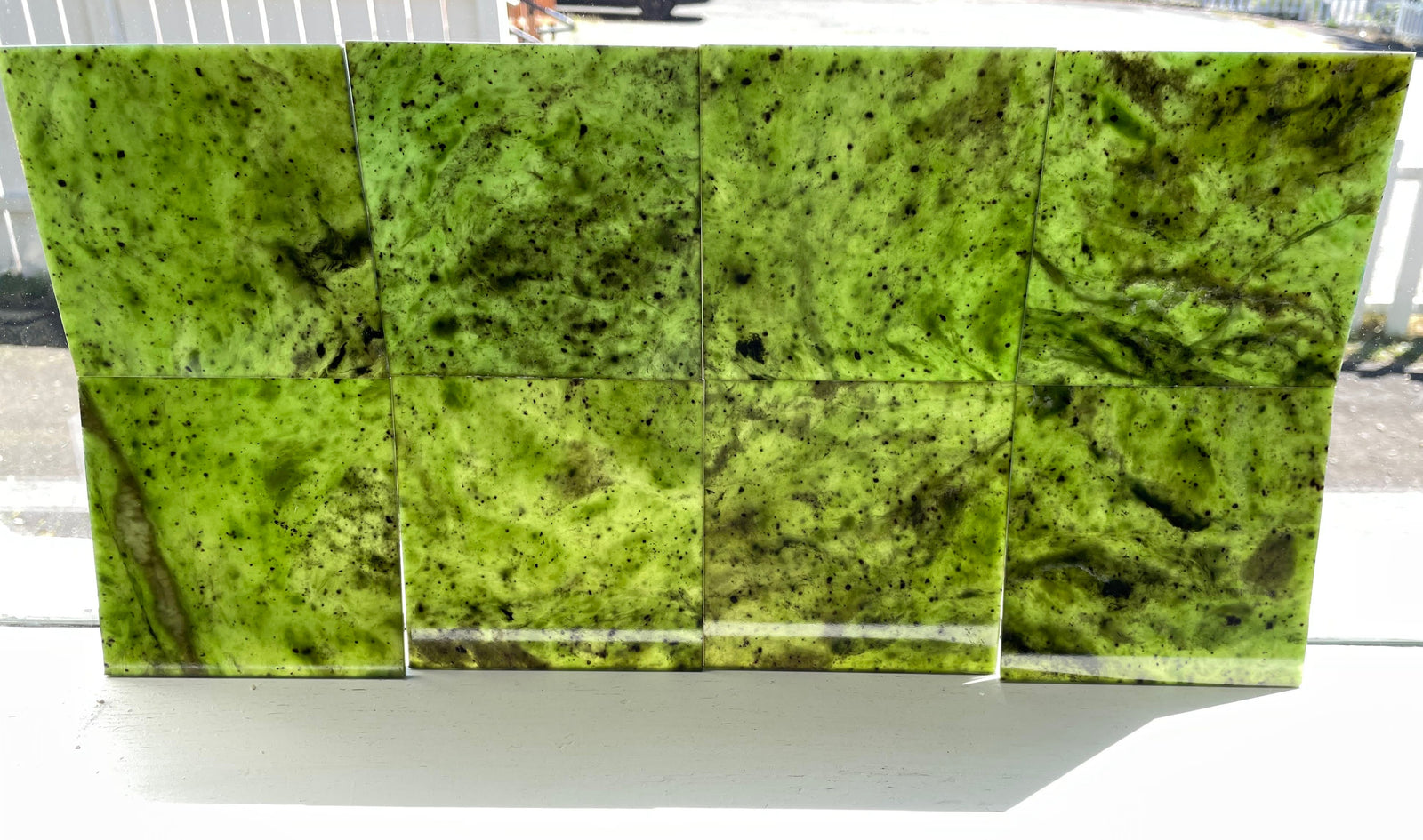 Eight 4x4 Canadian Jade tiles in bright green with black speckles arranged in two rows.