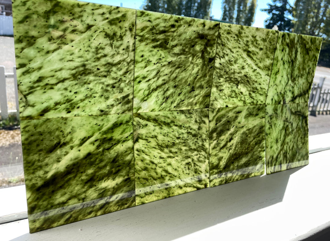 Glossy Canadian jade tiles arranged in a grid panel showcasing green veining.