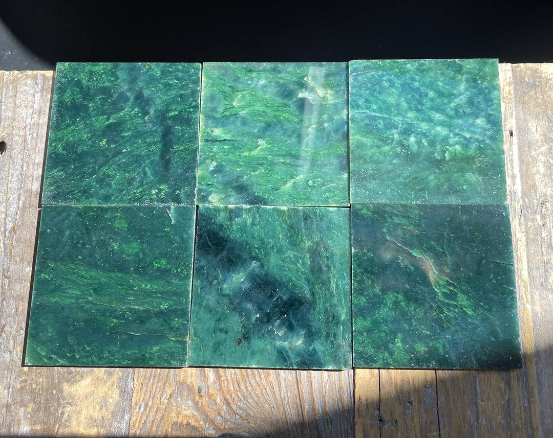 Six dark green Canadian Jade tiles laid in a grid showing swirling marbling.