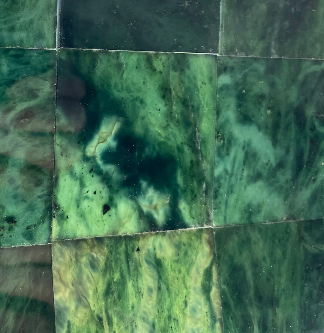 Close-up of dark green Canadian Jade tile surface with swirling marbling.