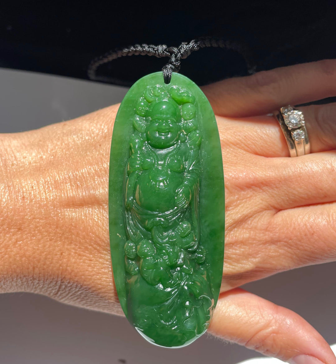 AA Siberian Jade Buddha pendant carved from vibrant green jade on a black cord