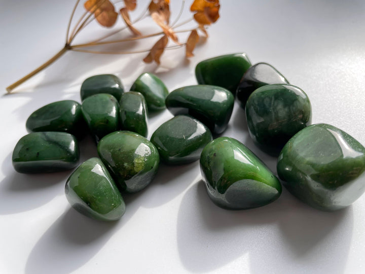 Polished jade nuggets in varying sizes from 1 to 2 inches with glossy green surfaces