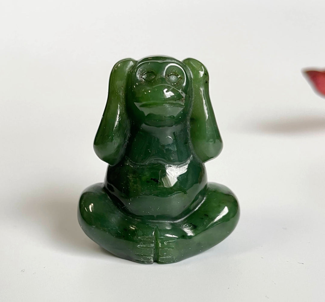 Jade monkey sculpture seated cross legged with a glossy deep green finish