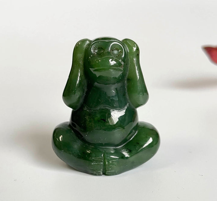 Jade monkey sculpture seated cross legged with a glossy deep green finish