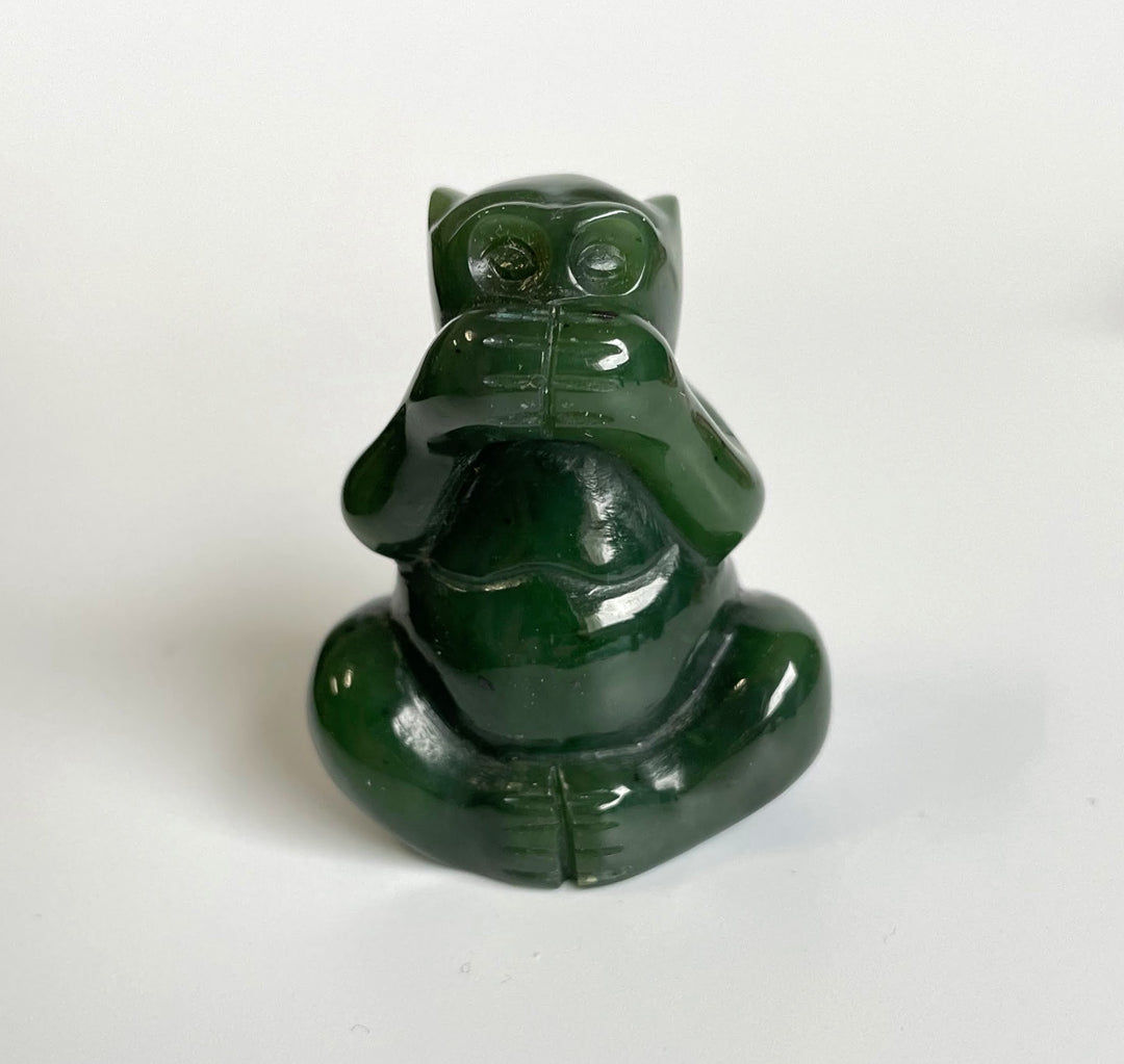 Back view of jade monkey statue showing glossy green surface and seated posture