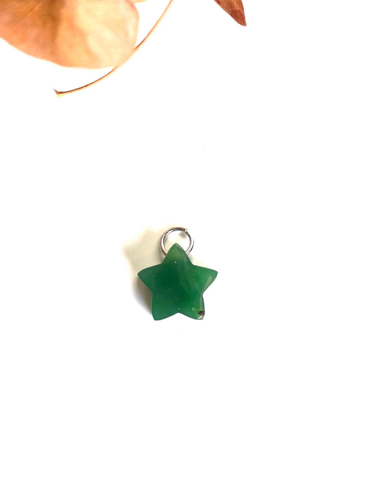 Single green jade star charm with a metal loop on a white background