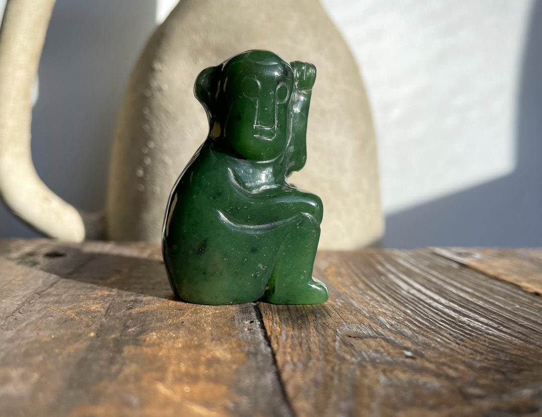 Dark green jade monkey figurine with a glossy finish.