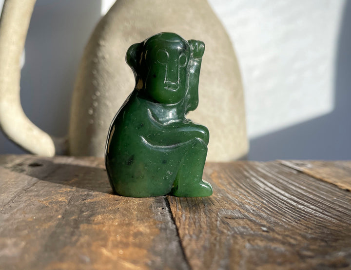 Dark green jade monkey figurine with a glossy finish.