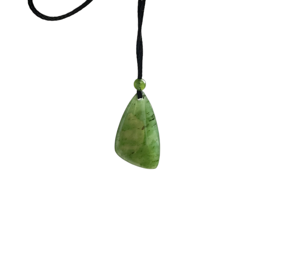 Green jade teardrop pendant on black cord with a small green bead at the knot.
