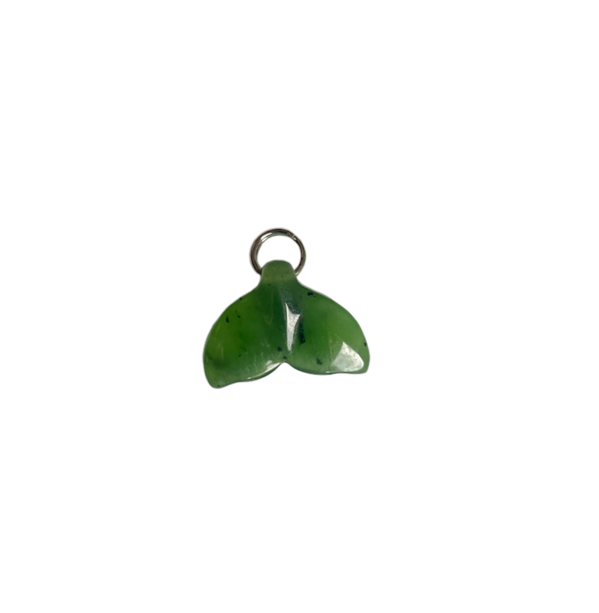 Green jade whale tail charm with a metal loop on a white background
