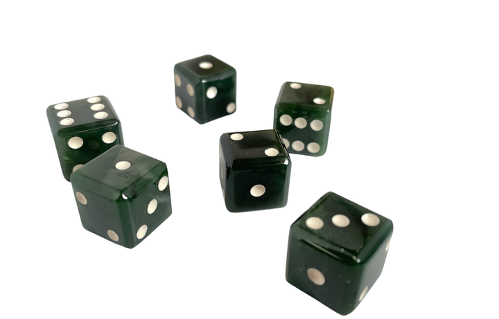 Group of six dark green dice with white pips scattered on a white background