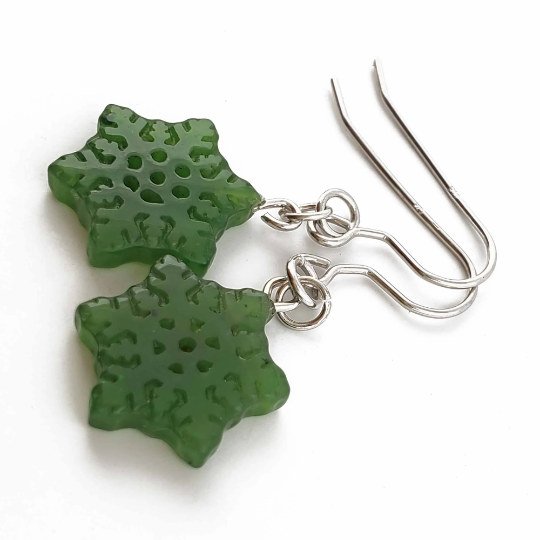 Close-up of green jade snowflake earrings with silver hooks
