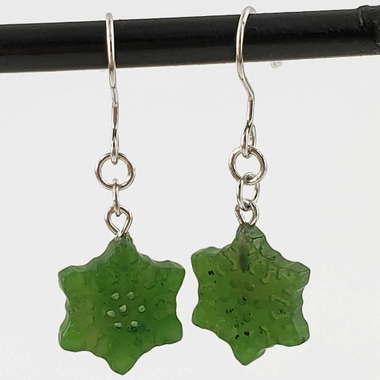 Pair of green jade snowflake earrings with silver ear hooks