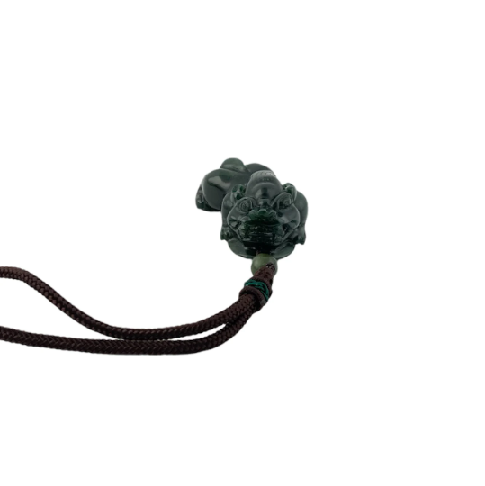Dark green jade Pi Xiu pendant on brown cord against a white background
