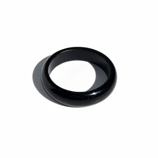 Glossy black jade ring with a smooth rounded band on a white background.