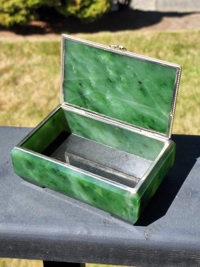 Siberian jade box with silver trim open outdoors showing jade base and silver interior tray.