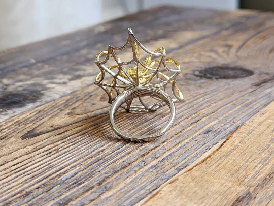 Side view of AA Spider Jade Ring in sterling silver with gold accents and spiderweb setting.