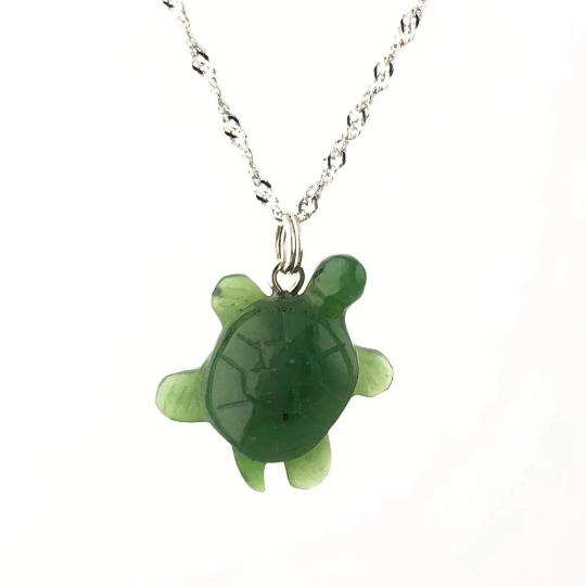 Green turtle pendant on a silver chain necklace