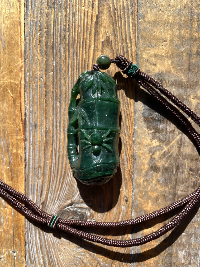 Jade Spider Pendant carved from green jade with brown cord necklace and green bead accents