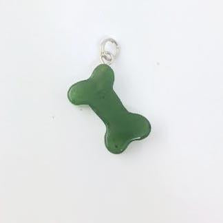 Green Jade Dog Bone Charm, on a grey background