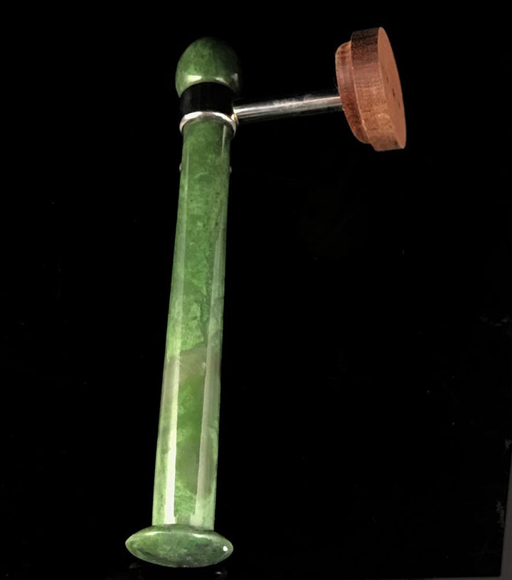 Green marble toilet paper holder stem with round wooden end cap and metal connector.