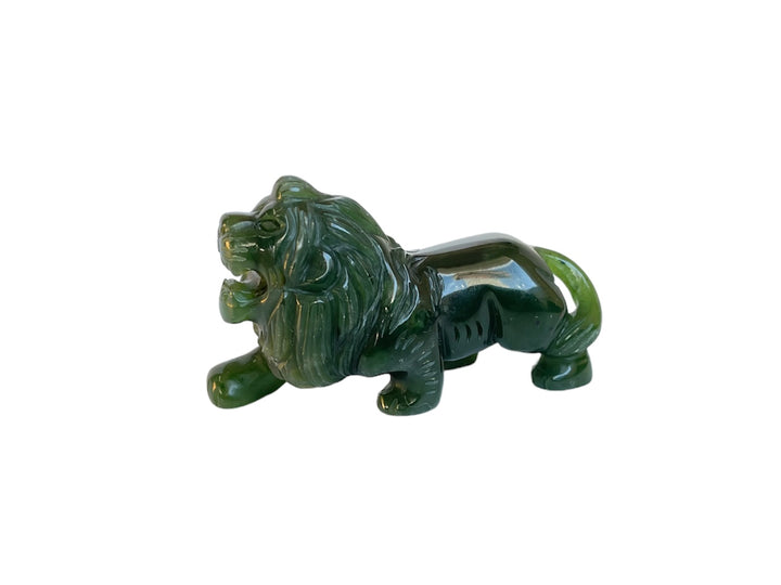 Green jade lion sculpture seen in profile against a white background