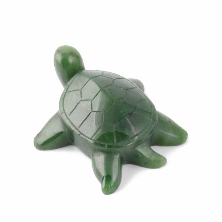Glossy jade turtle sculpture with a segmented shell on a white background
