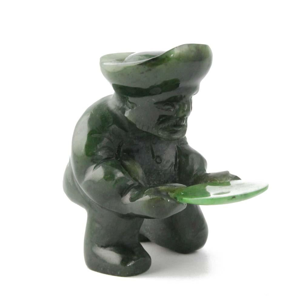Green stone gold panner figurine kneeling and holding a round pan.