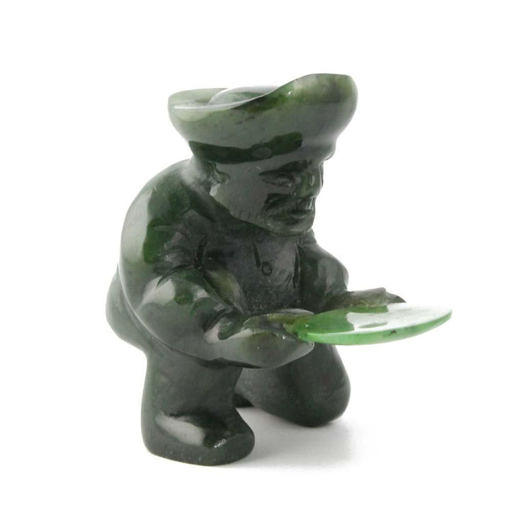 Green stone gold panner figurine kneeling and holding a round pan.