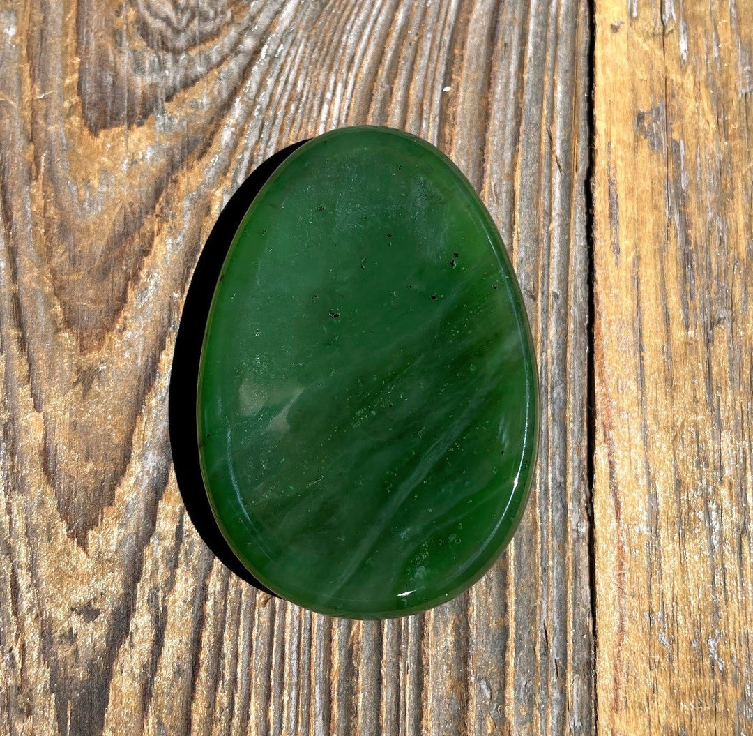 Green Jade Worry Stone on a wooden base