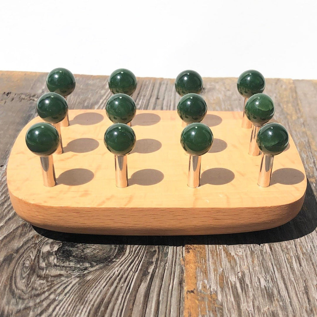 New Massage Tool 4411 with green knob heads on a wooden base