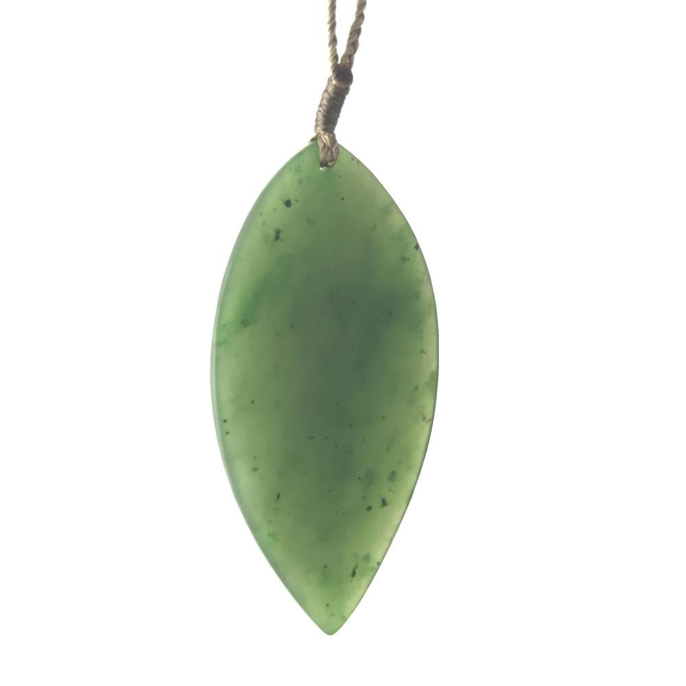 Green jade leaf pendant hanging from a brown cord.
