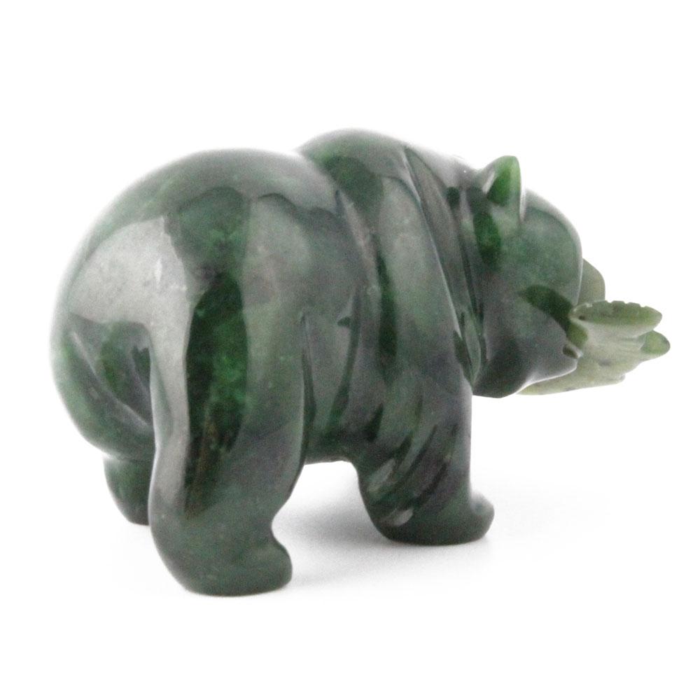 Dark green grizzly bear figurine with a fish in its mouth