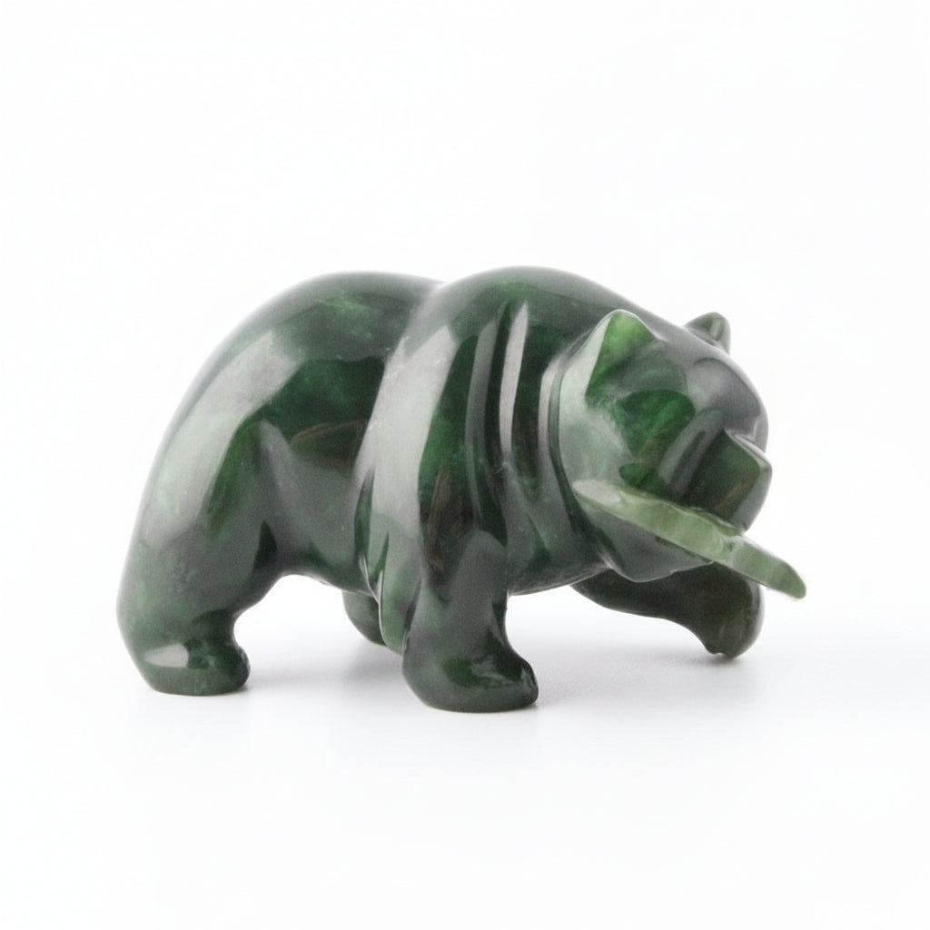 Dark green jade bear with a jade fish in its mouth, white background