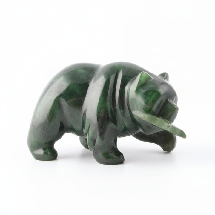 Dark green jade bear with a jade fish in its mouth, white background