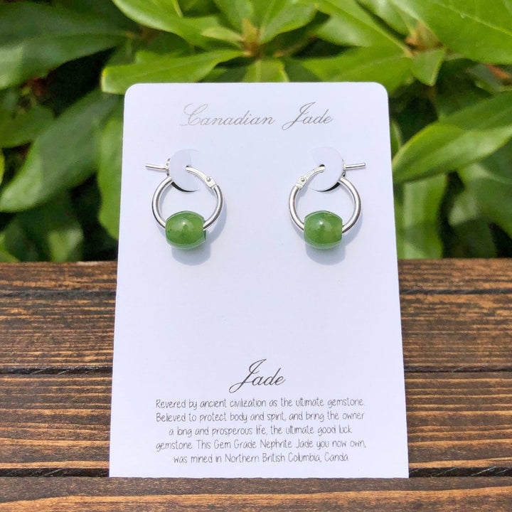 Green jade bead earrings on sterling silver hoops mounted on a white Canadian Jade branded display card