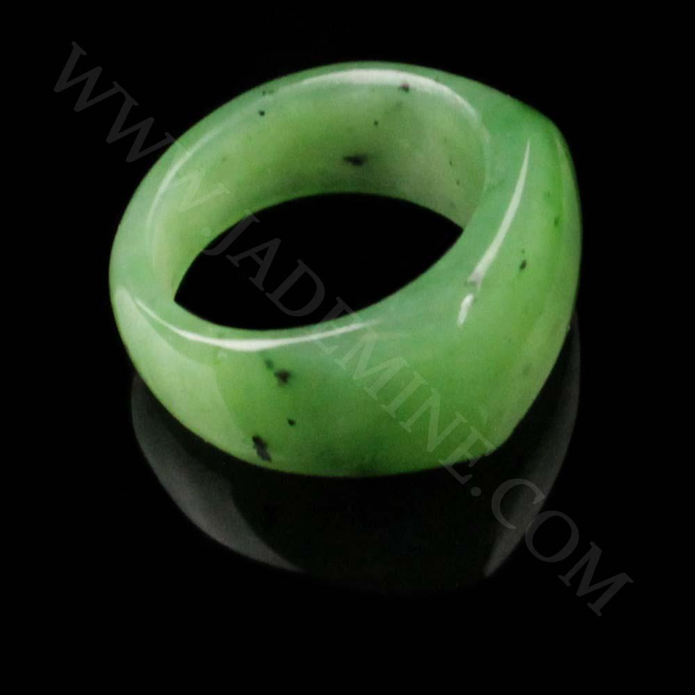 Close-up view of a green jade saddle top band ring from the side.
