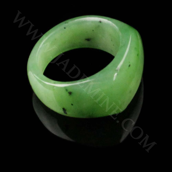 Close-up view of a green jade saddle top band ring from the side.