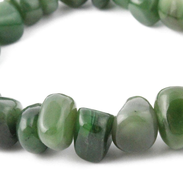 Power Beads Nugget green jade bead strand with smooth irregular nuggets on white background.