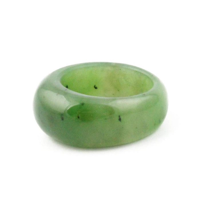 Green jade dome top band ring photographed from a slight angle to highlight its rounded form